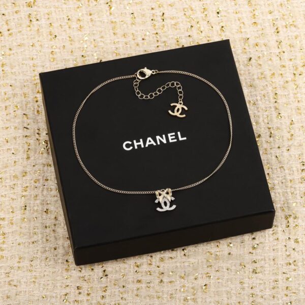 Chanel light gold bow hanging silver double c necklace
